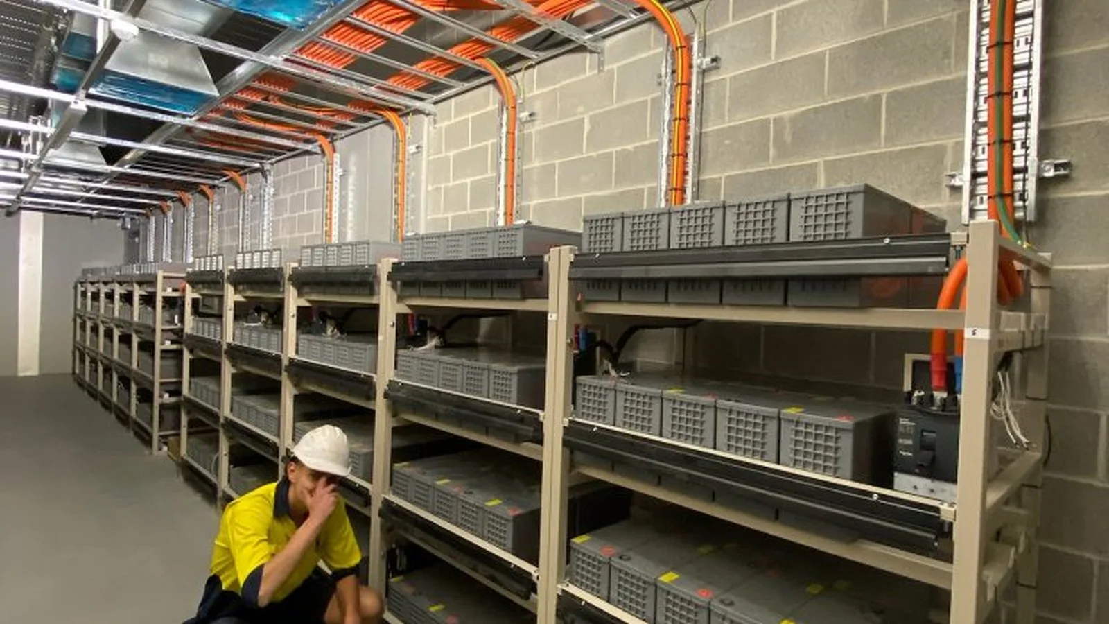 Conduit and cable tray run through a new building at rough-in stage